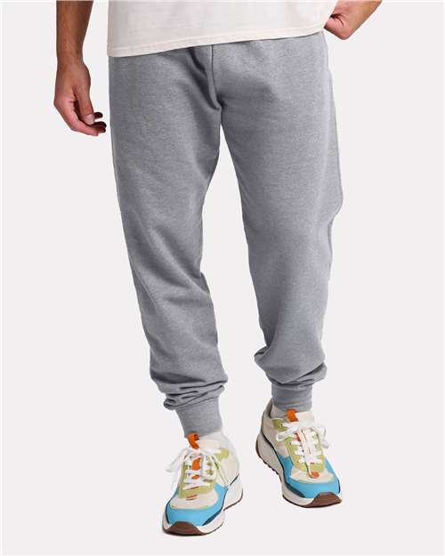 JERZEES JERZEES IC50MPR Joggers with Custom Company Logo Printing in Athletic Heather, front view on model