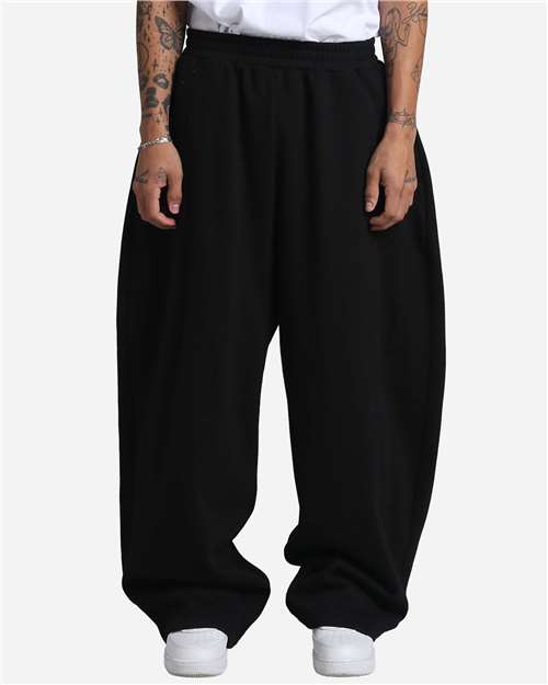 Shaka Wear Unisex Balloon Fleece Pants in Black, front view on model