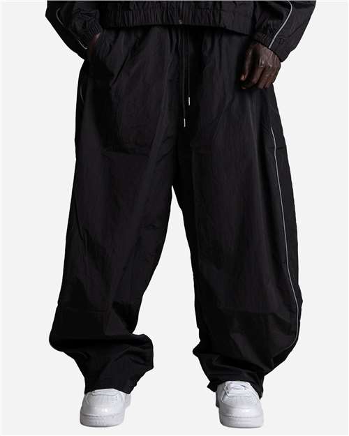 Shaka Wear Unisex Wind OPPS Reflective Balloon Pants in Black, front view on model